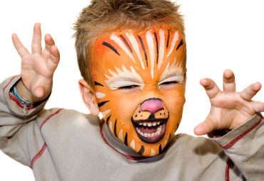 Kid with lion painted face. On white background.