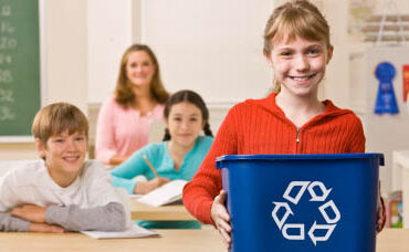 Student carrying recycling bin